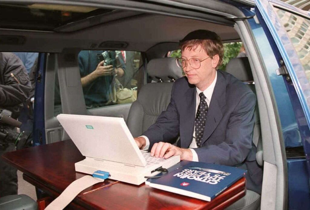In 1995, Microsoft president Bill Gates demonstrated Microsoft’s Windows 95 program from his automobile prior to a press conference in Paris 04 September.